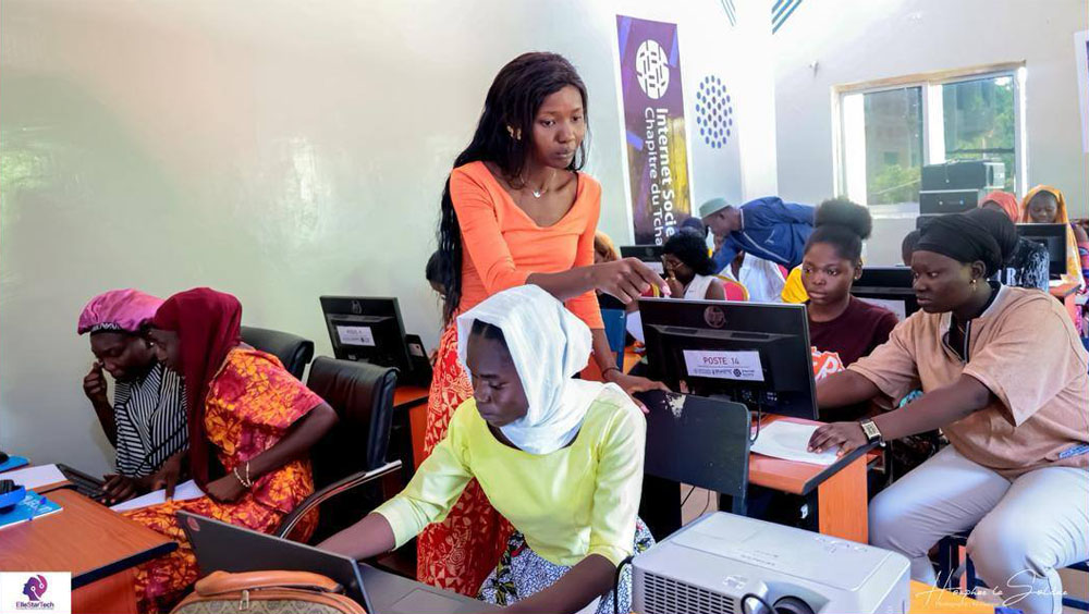 A group of women sit at computers at a Chad Chapter training