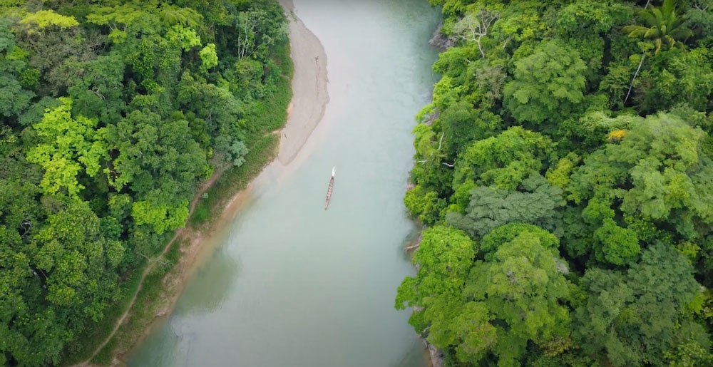 A boat moves down the center of the Chagres River