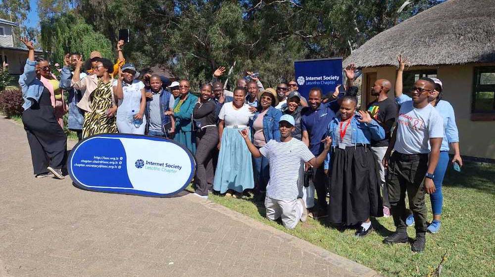 A group of people outside with an Internet Society Lesotho Chapter sign